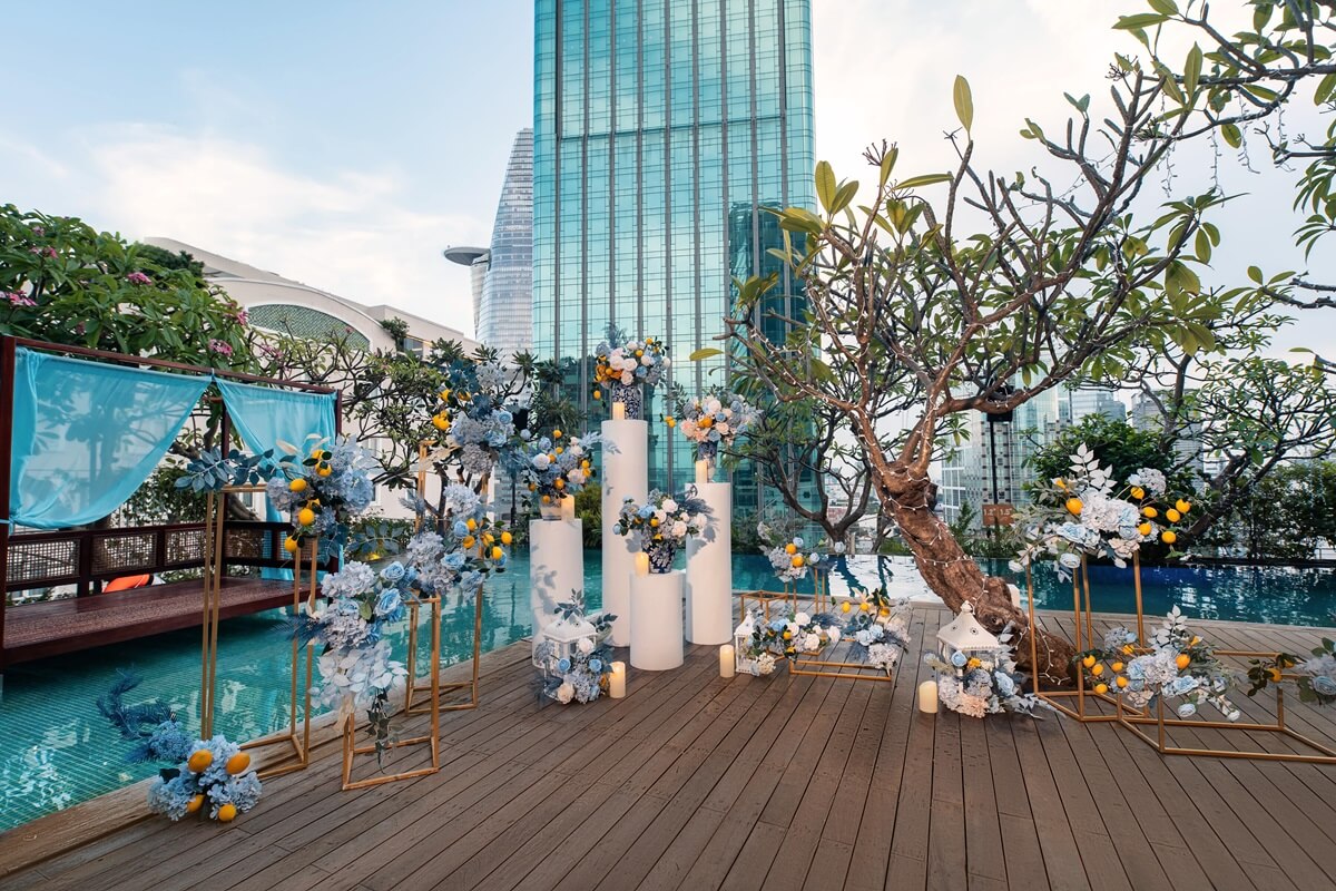 Wedding Trends 2026-2027: Where Celebrations Are Heading 1 An intimate wedding set-up beside the pool at The Myst Dong Khoi, city buildings behind