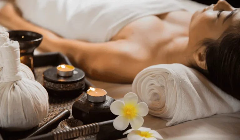 KL Spa: a hotel spa in District 1 for tired feet, stiff shoulders and slow evenings 1 A treatment in progress at KL Spa inside The Myst Dong Khoi, with herbal compress balls, a candle and a rolled towel