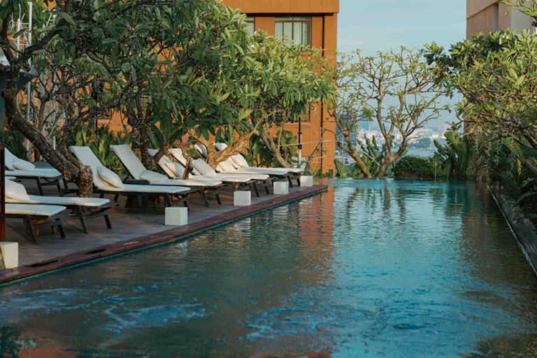A rooftop pool hotel in District 1: swimming, sauna and gym at The Myst Dong Khoi 1 The 24-metre rooftop infinity pool on the 15th floor of The Myst Dong Khoi in late afternoon, the city and the Saigon River beyond