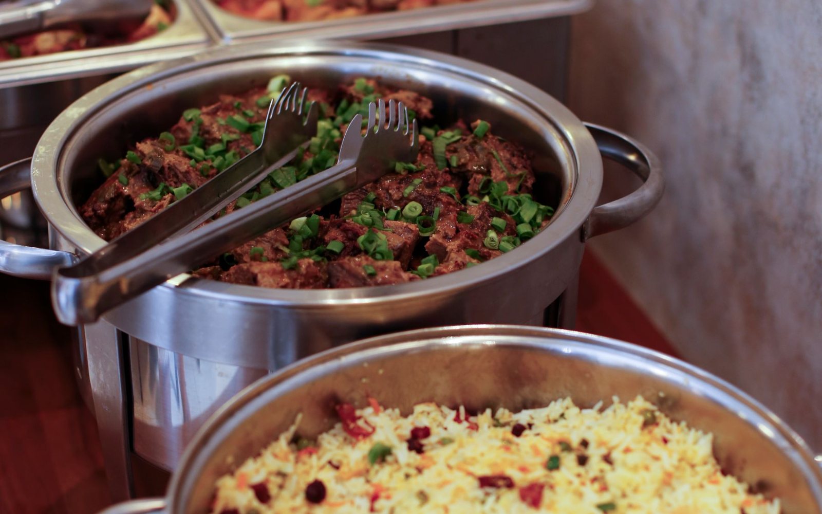 Year-End Party: Buffet or Set Menu? A Decision Guide 1 Buffet stations laid out with warm dishes for a year end party