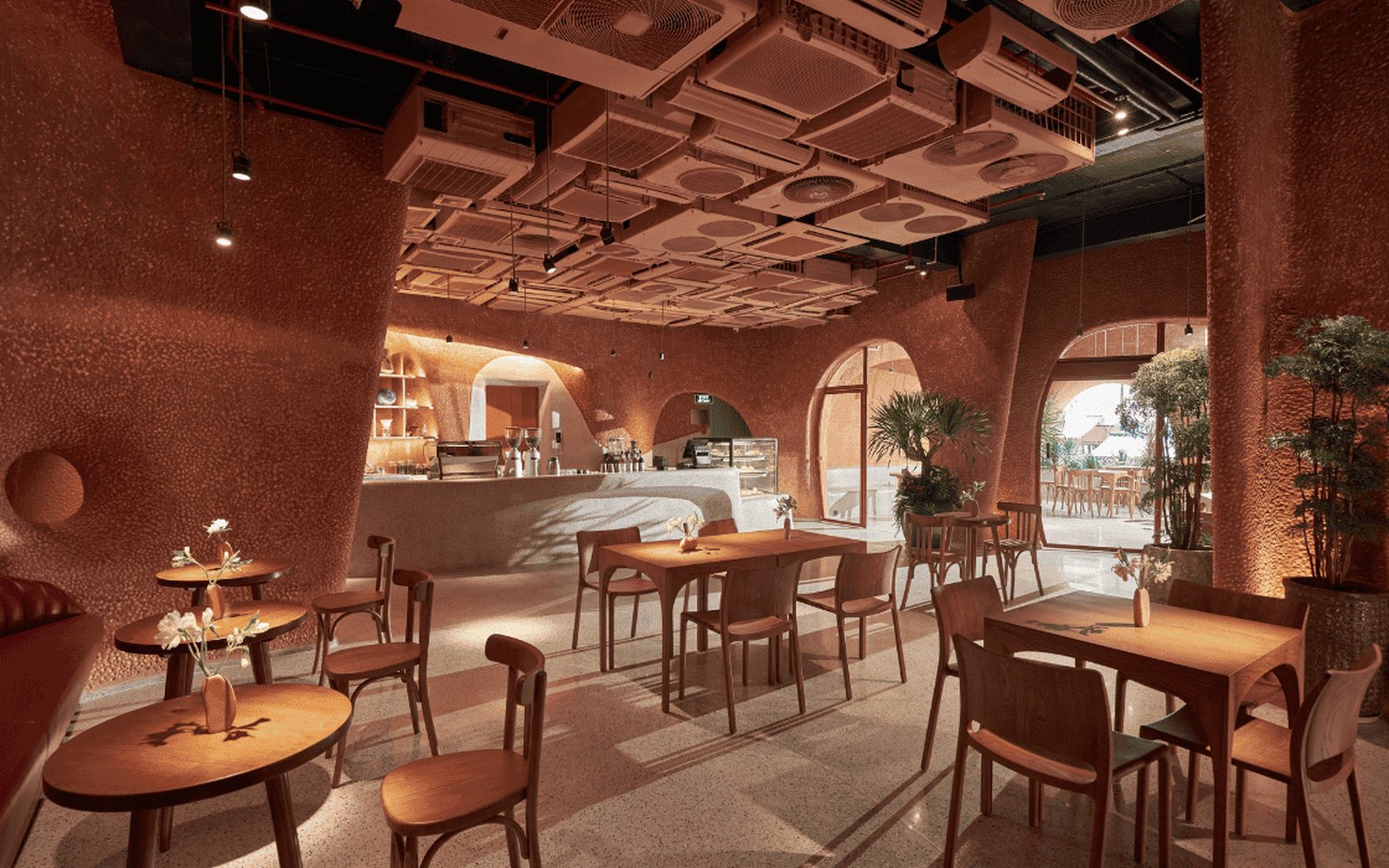 A Café by Ben Thanh Metro: Where to Pause After the Art 1 Bason Cafe Ben Thanh interior in earthy terracotta tones, with the sculpted ceiling of stacked units above
