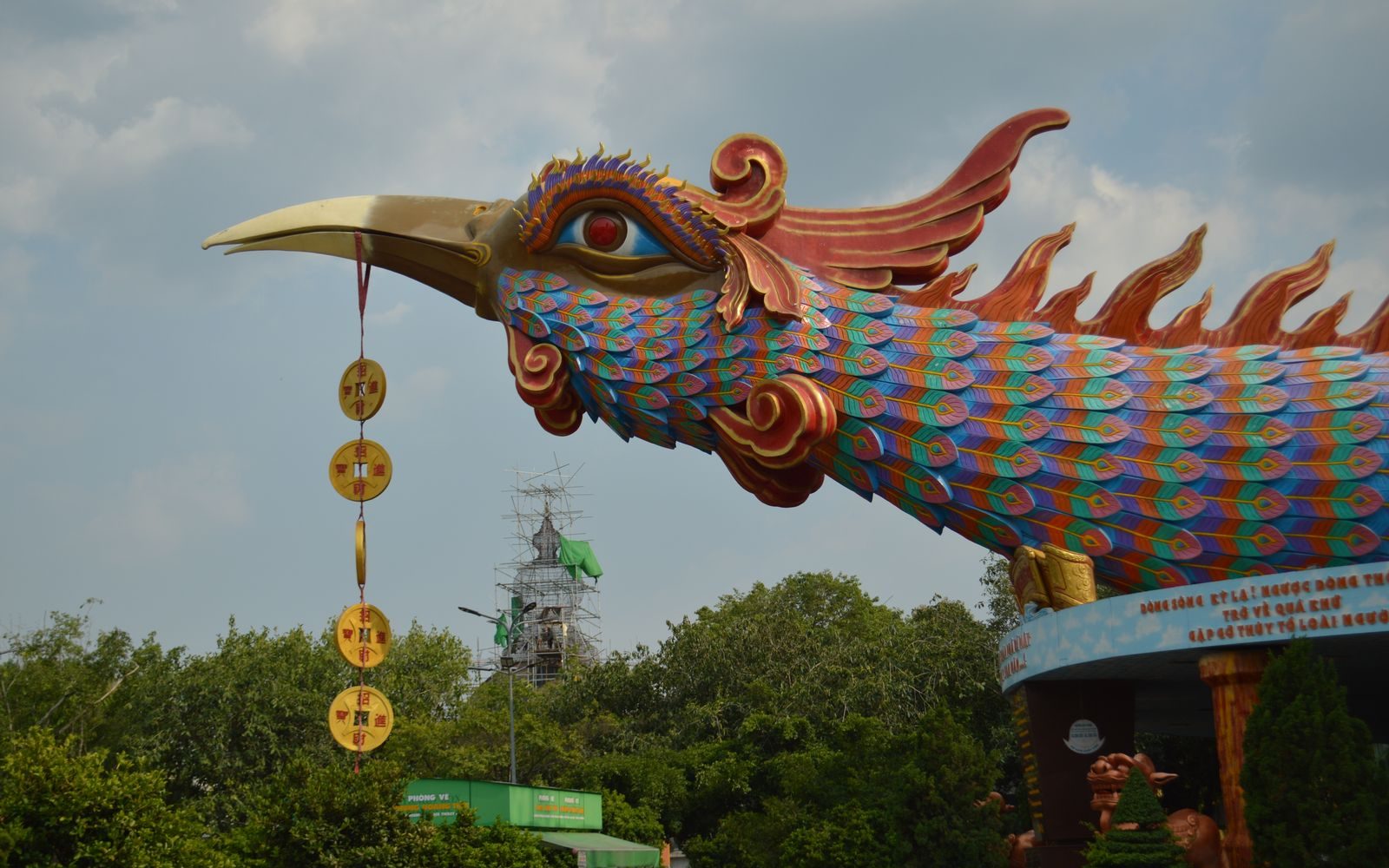 An ornate ceramic phoenix figure on the roof of a historic Chinese temple in Cholon, Saigon