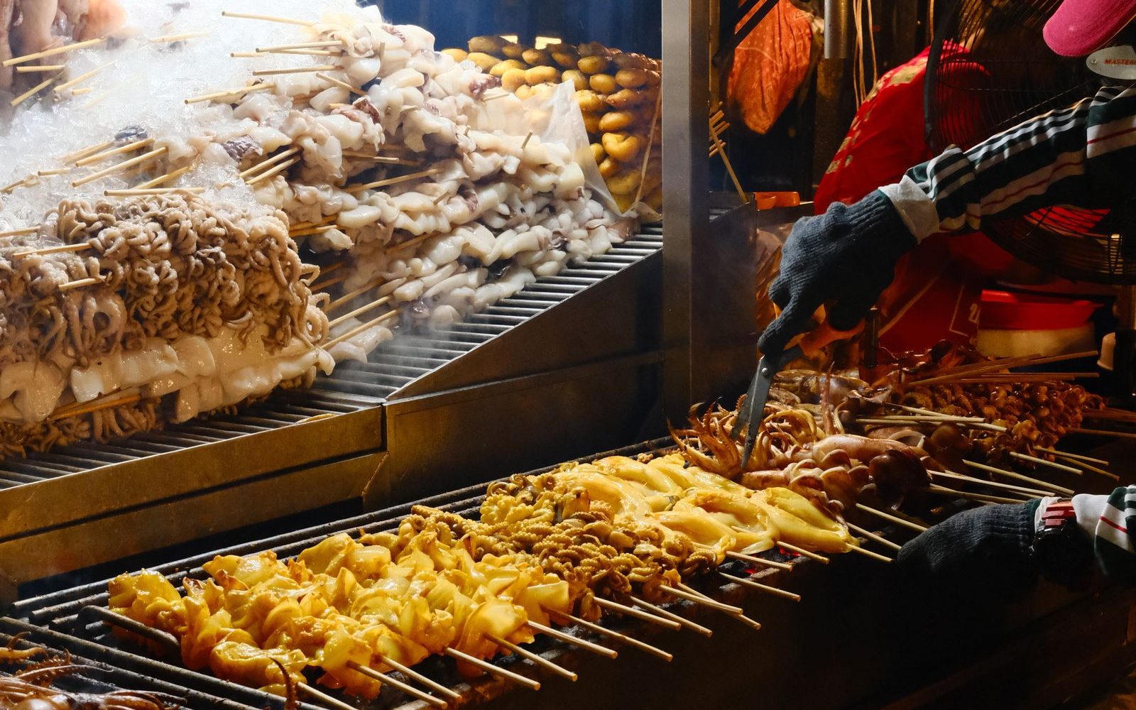 District 4, Saigon: Seafood Street and Night Food Guide 2 A street stall grilling seafood and skewers over charcoal at a Saigon night food market