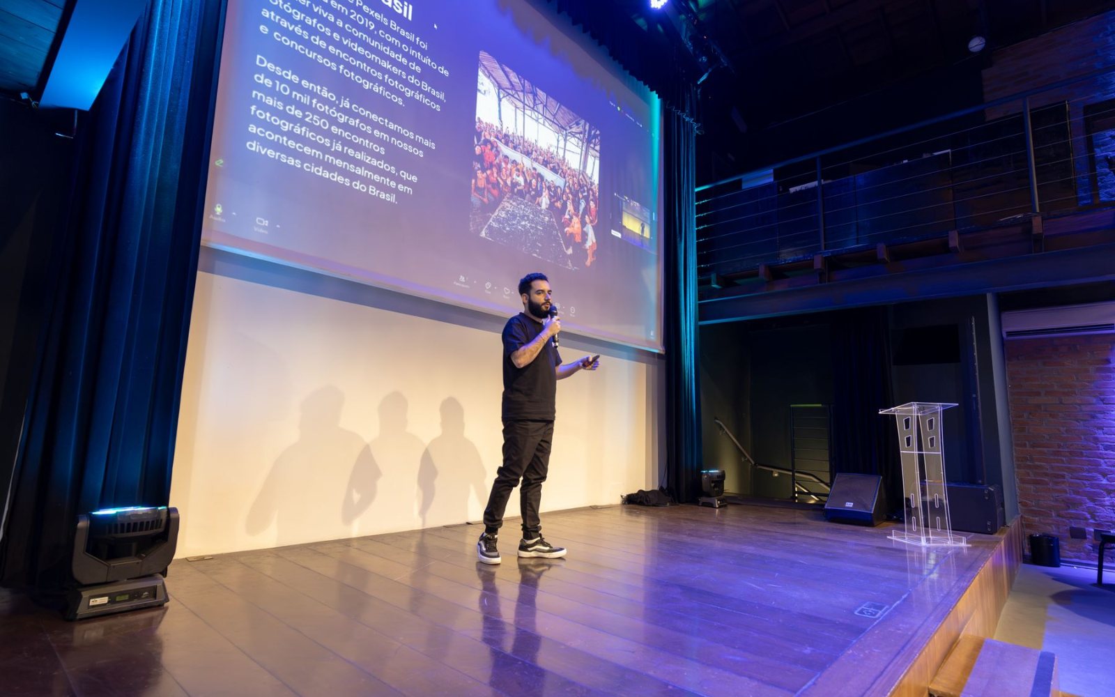 7 Year-End Party Mistakes Companies Make (and How to Avoid Them) 2 A host on a lit stage with a large screen during an event programme