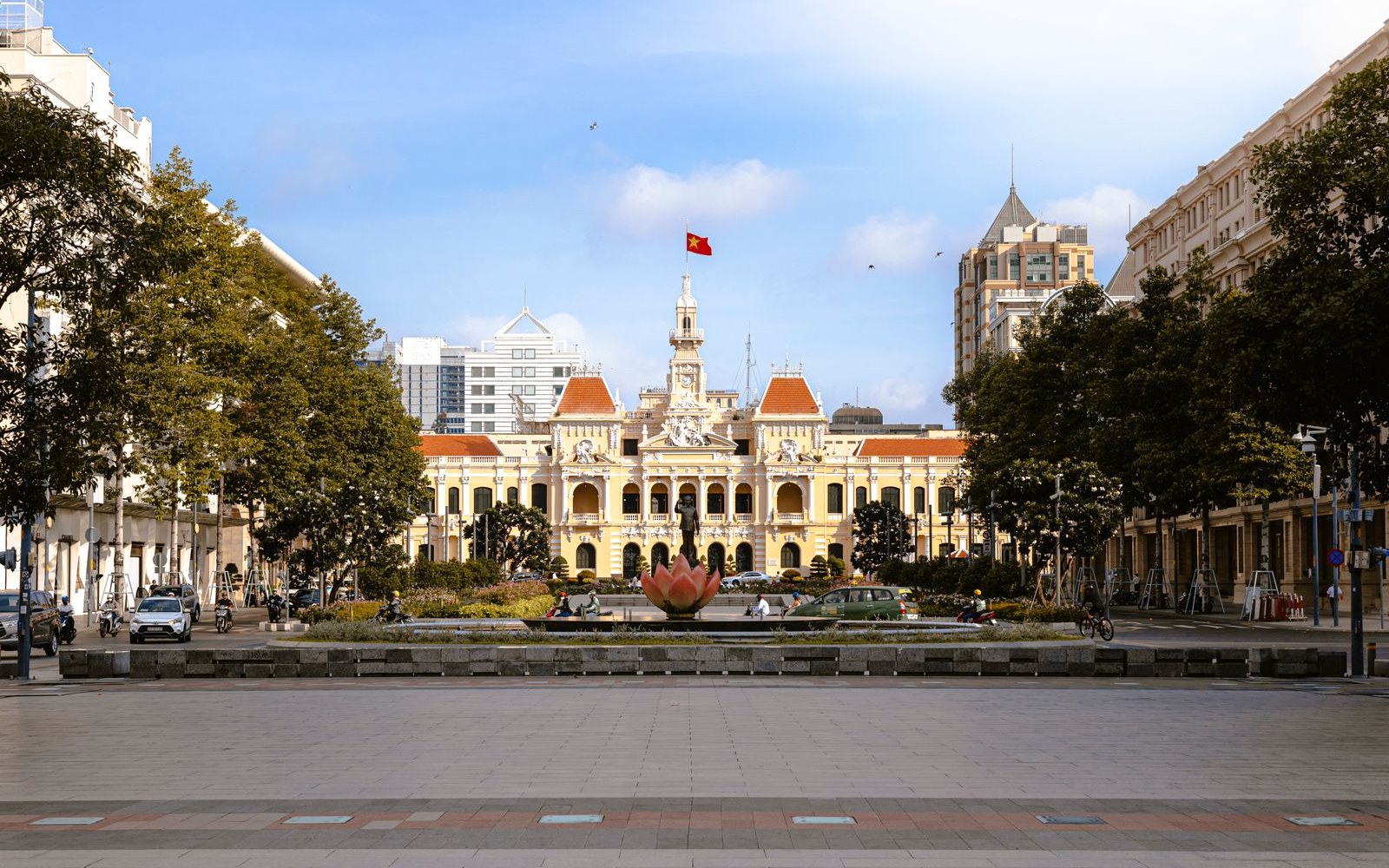 What's within 15 minutes' walk of The Myst Dong Khoi 2 The wide Nguyen Hue pedestrian promenade looking toward Ho Chi Minh City Hall, near-empty in the early morning